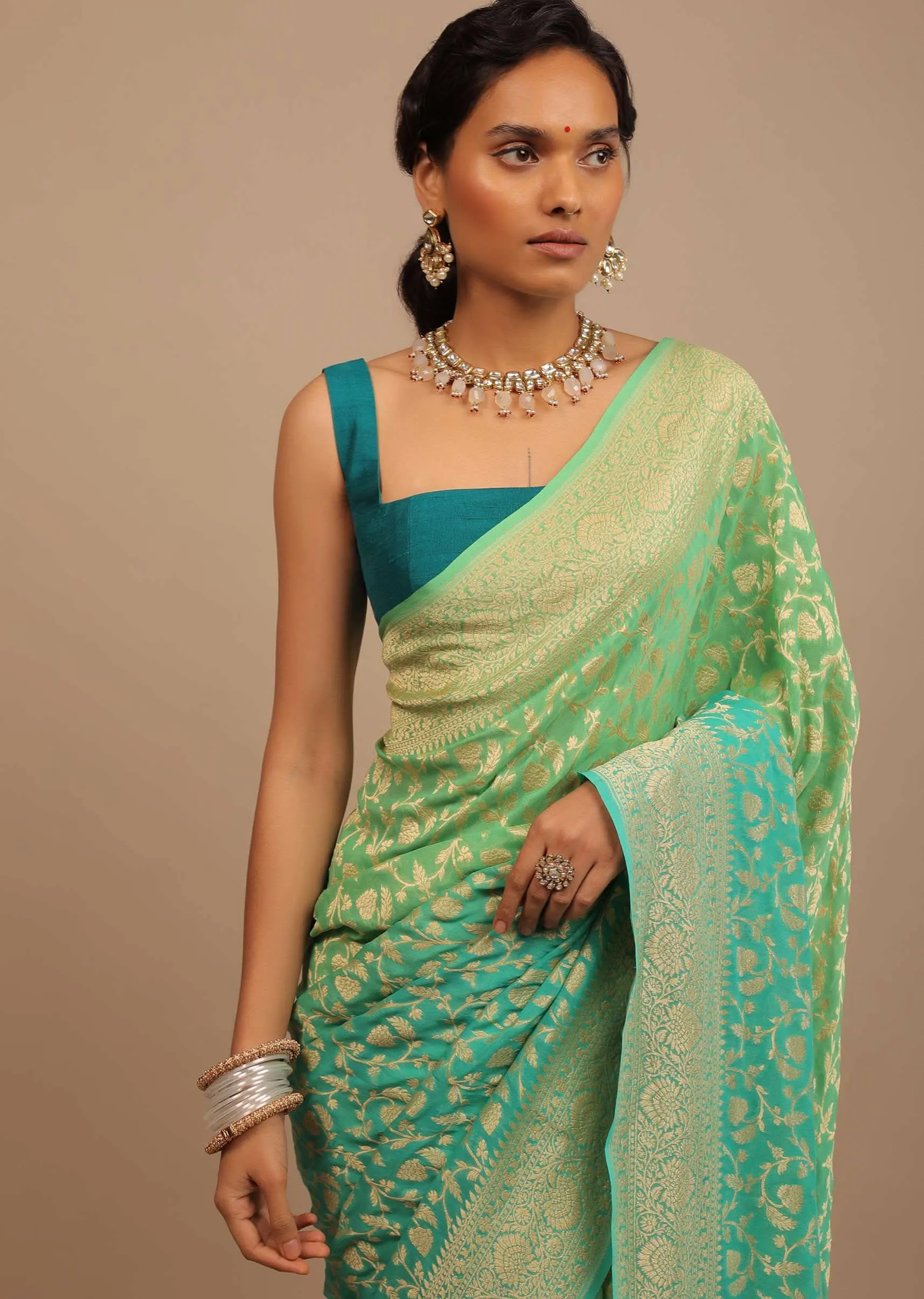 Jade Green Saree Made In Georgette And Beautified With Golden Jaal In A Floral Pattern