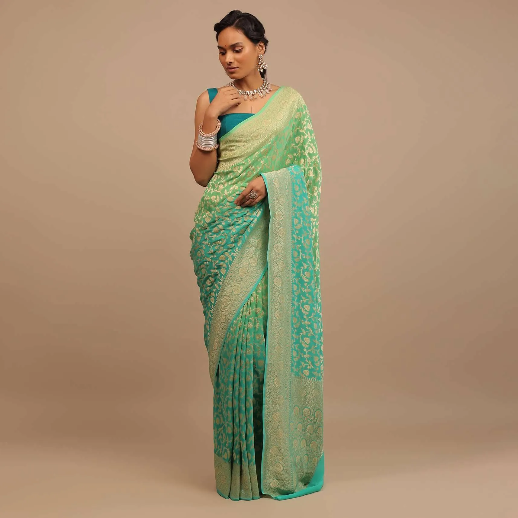 Jade Green Saree Made In Georgette And Beautified With Golden Jaal In A Floral Pattern